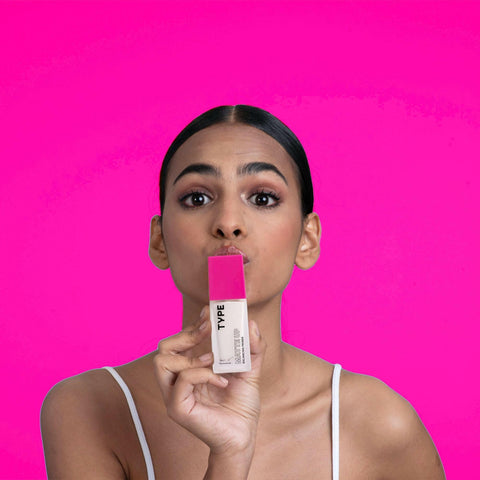 Model showcasing MATTE UP BALANCING PRIMER against pink background.