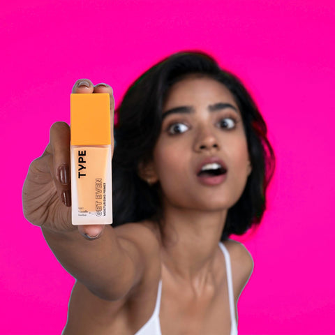GET EVEN Moisturizing Primer held by excited model, vibrant pink background.
