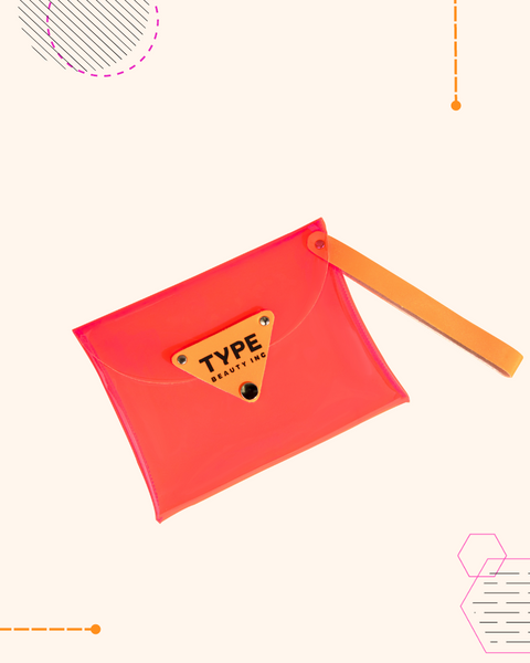 Colorful transparent makeup bag with orange strap and stylish design.