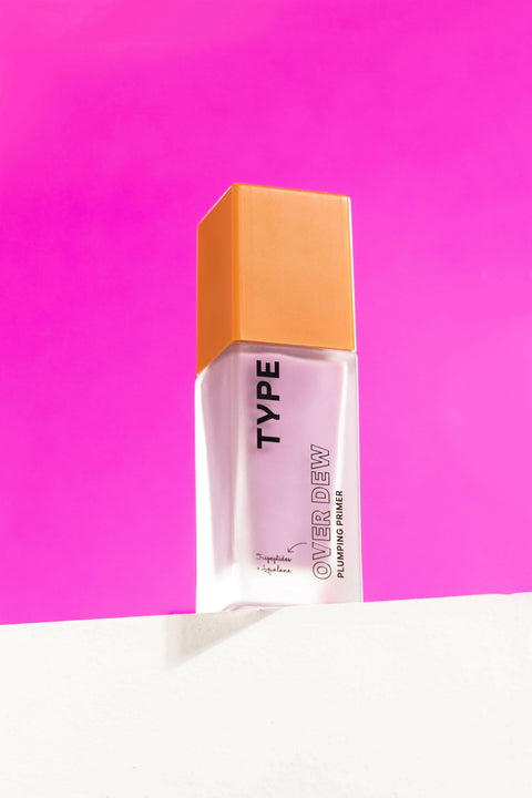 OVER DEW Plumping Primer on a bright pink background.