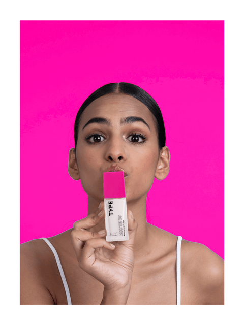 Model showcasing primer sample set against bright pink background.