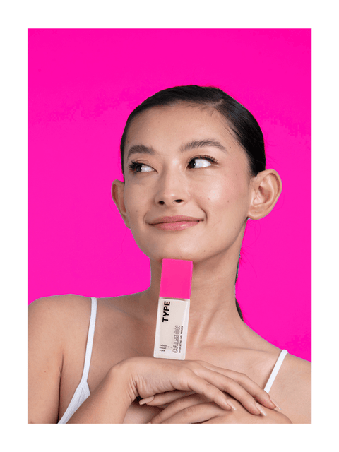 "Primer sample set displayed by model with vibrant pink background."