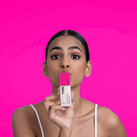 MATTE UP BALANCING PRIMER with model on vibrant pink background.