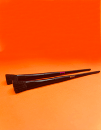 Two makeup brushes on an orange background, promoting "BRUSH UP ON SCIENCE."